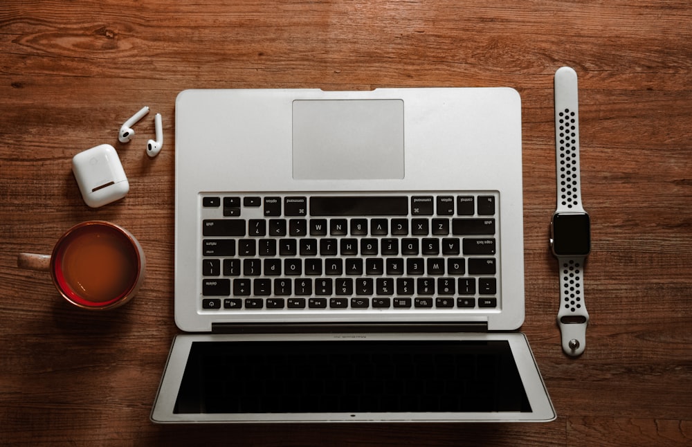 macbook pro on brown wooden table