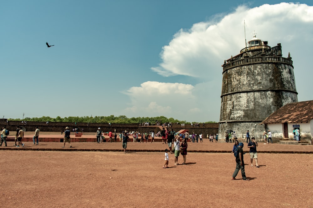 people standing near grey concrete building during daytime