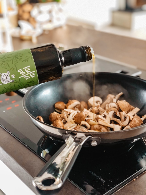 Brown and black mushroom on black frying pan