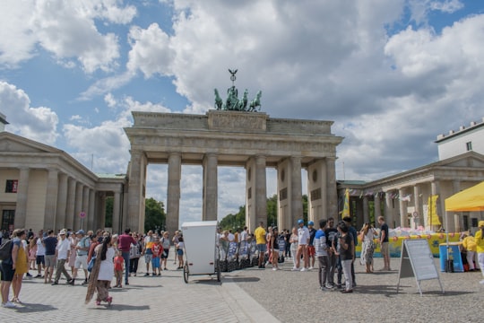 people walking around a white building in Brandenburg Gate Germany