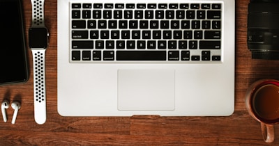 A flat lay of digital ebooks and a laptop on a clean desk.