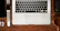A flat lay of a sleek productivity planner surrounded by a laptop and coffee cup.