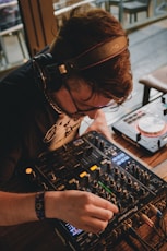 man in black t-shirt playing audio mixer