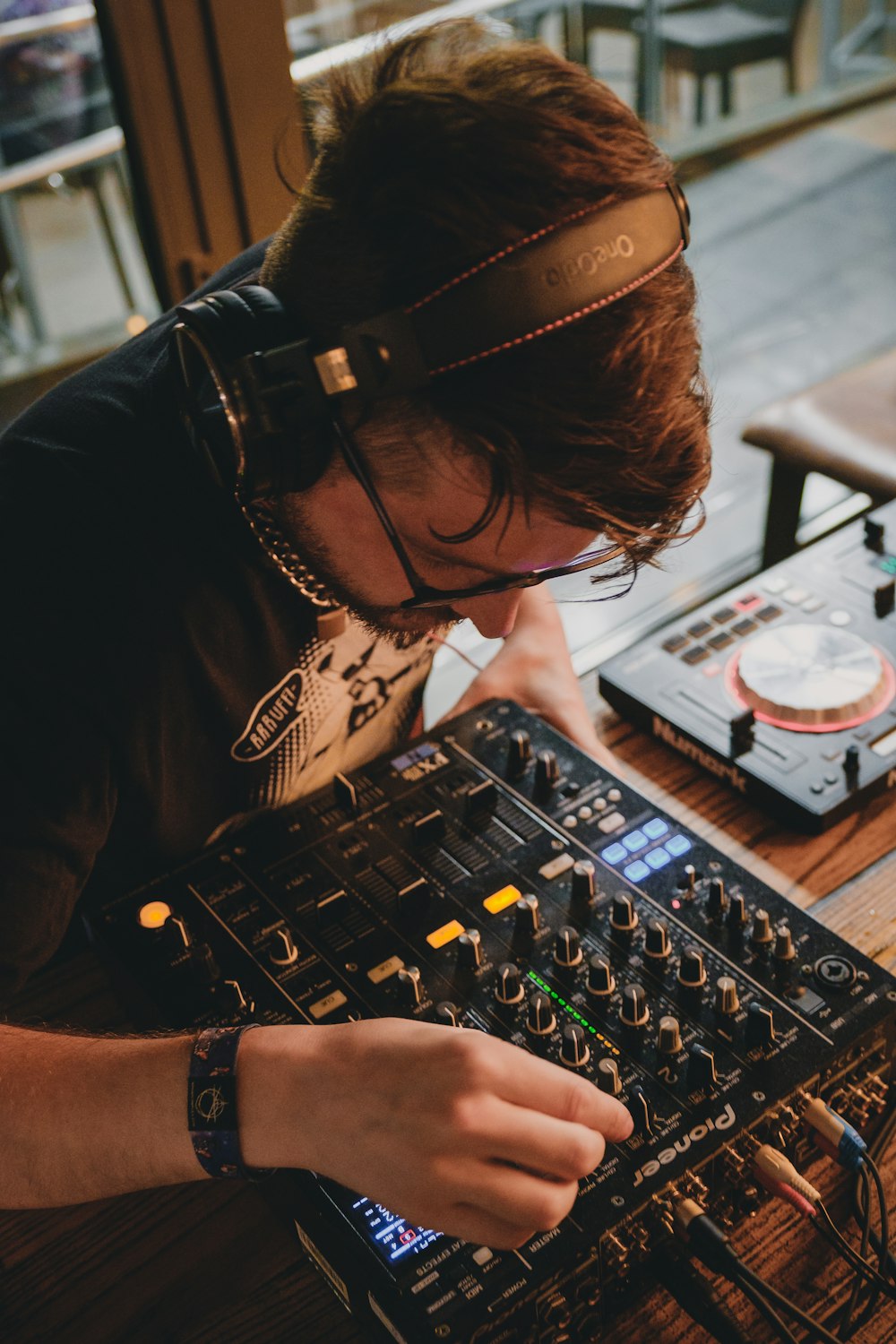 man in black t-shirt playing audio mixer