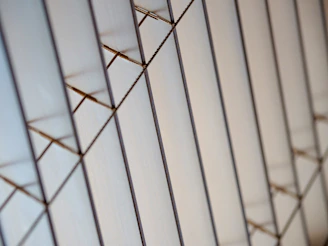 Close-up of sharp, intersecting lines forming a precise, minimalistic pattern.