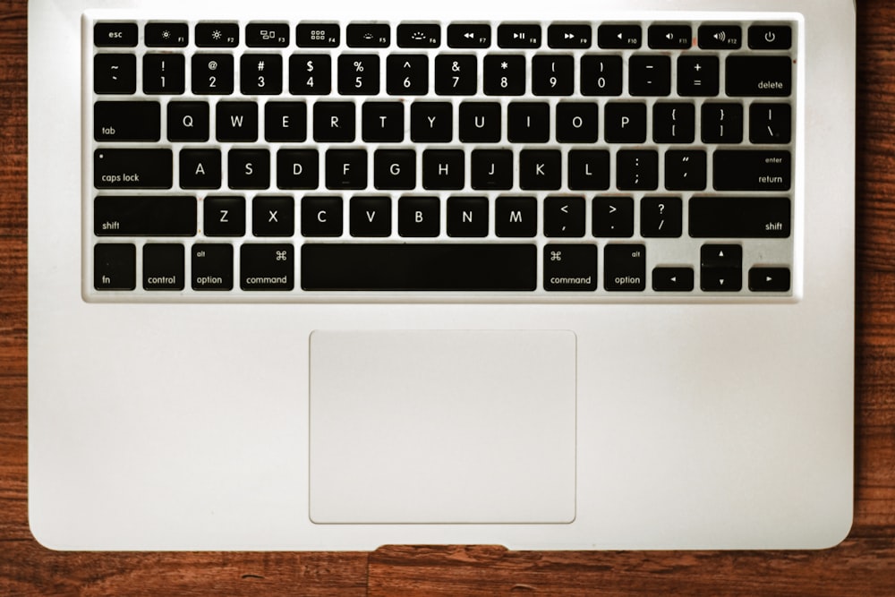 macbook pro on brown wooden table