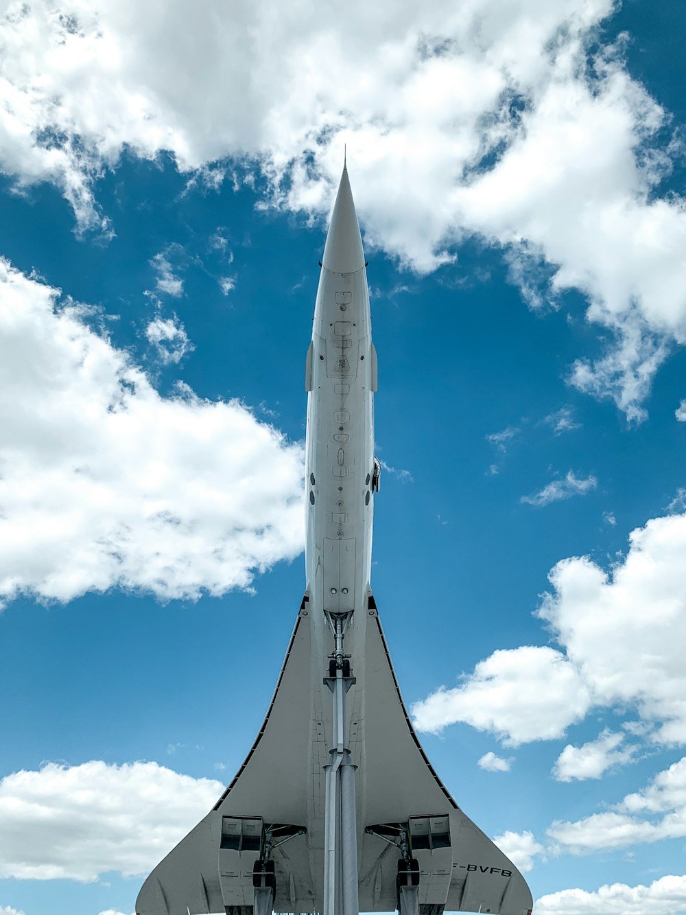 white and gray space ship under blue sky and white clouds during daytime