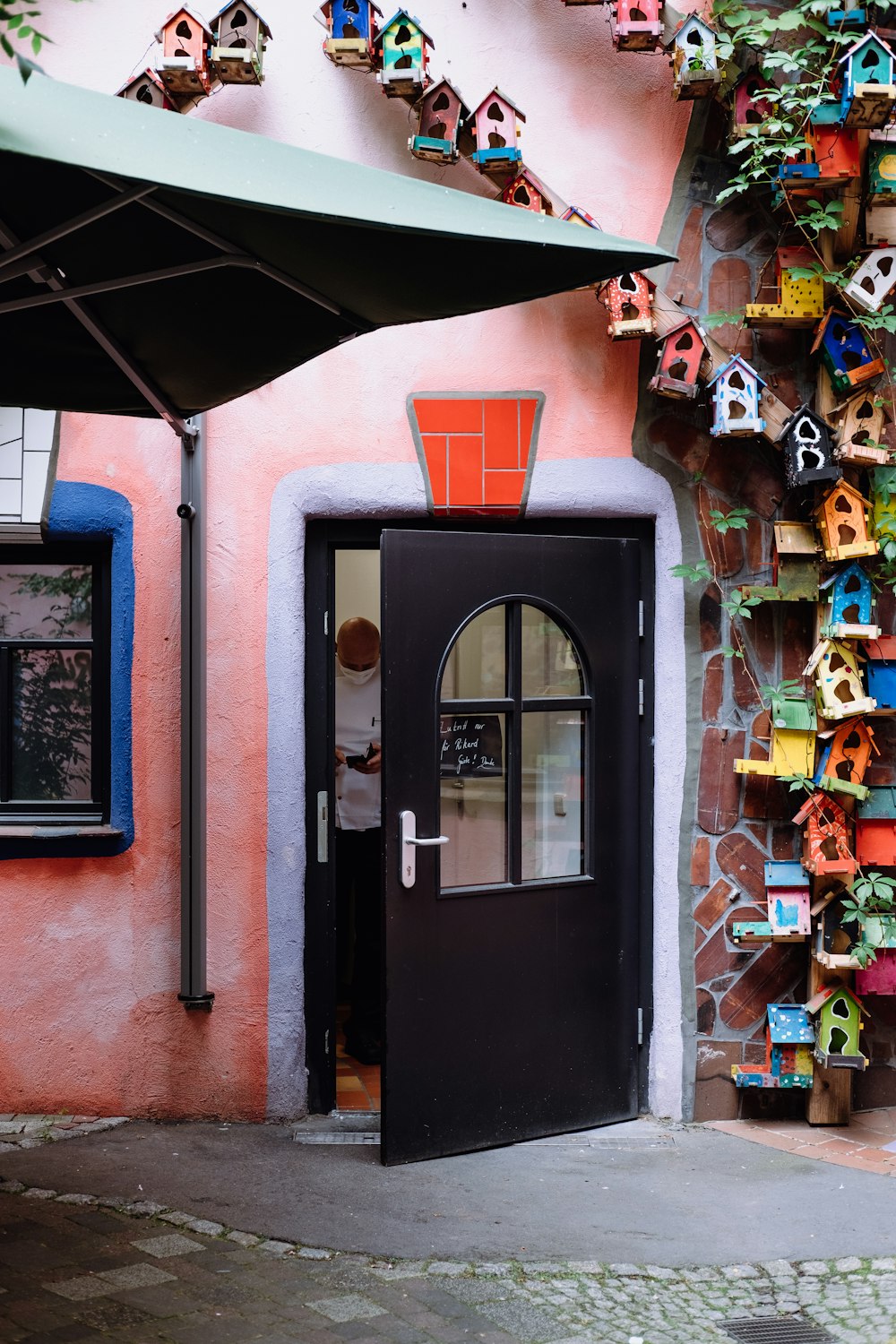 red plastic seat beside blue wooden door