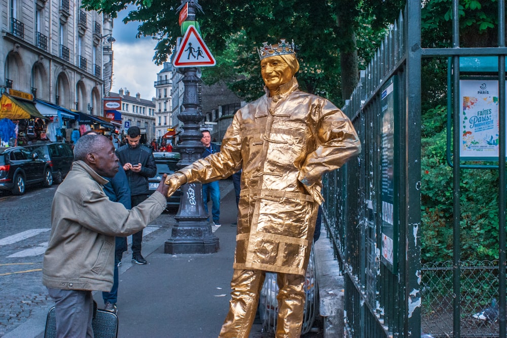 man in gold suit statue