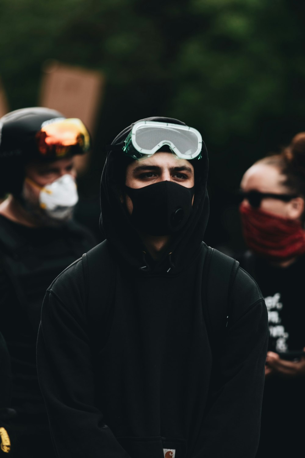 man in black hoodie wearing white goggles