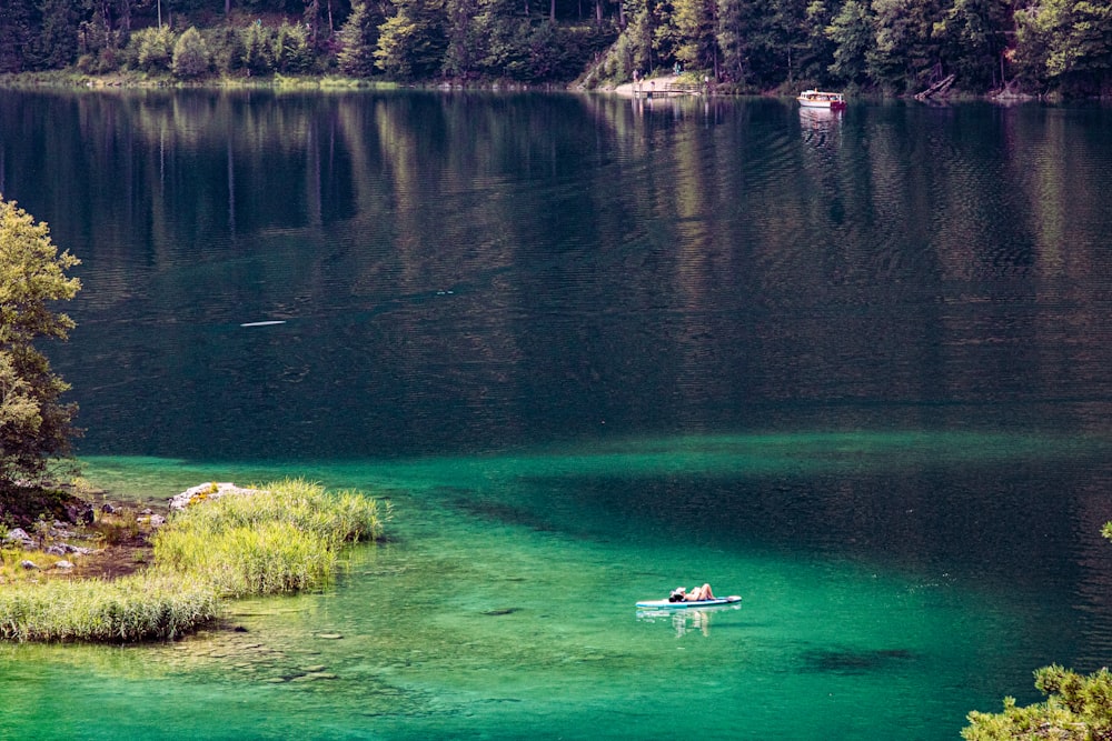 white boat on body of water during daytime