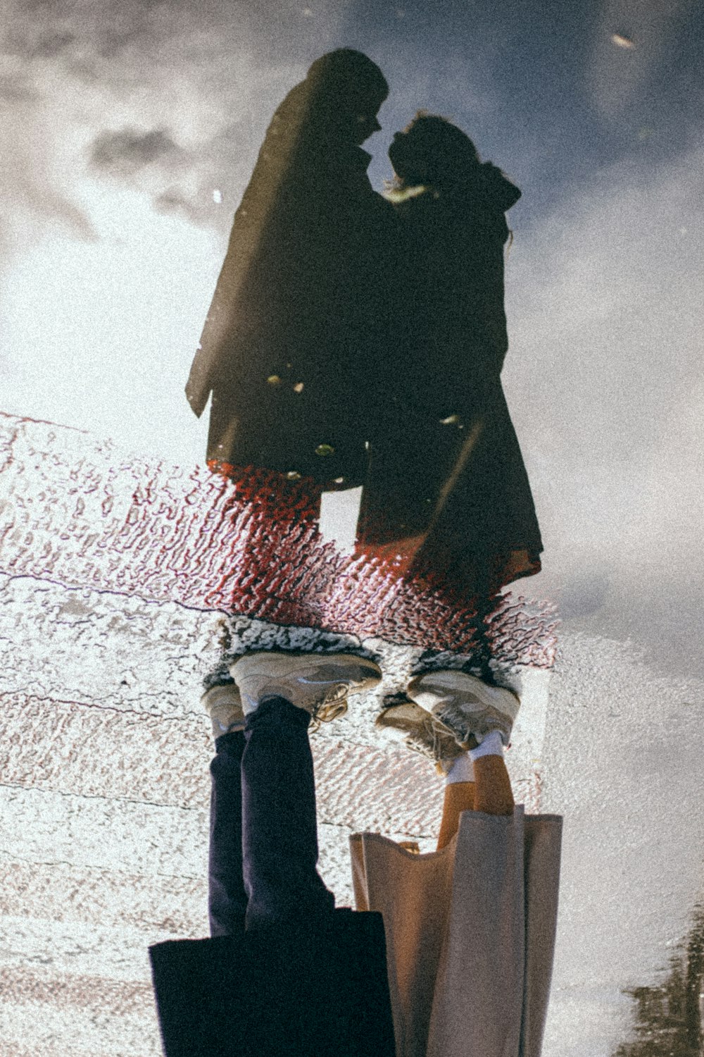 man in black coat standing on snow covered ground