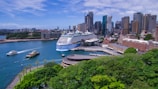 a cruise ship docked in a harbor with a city in the background
