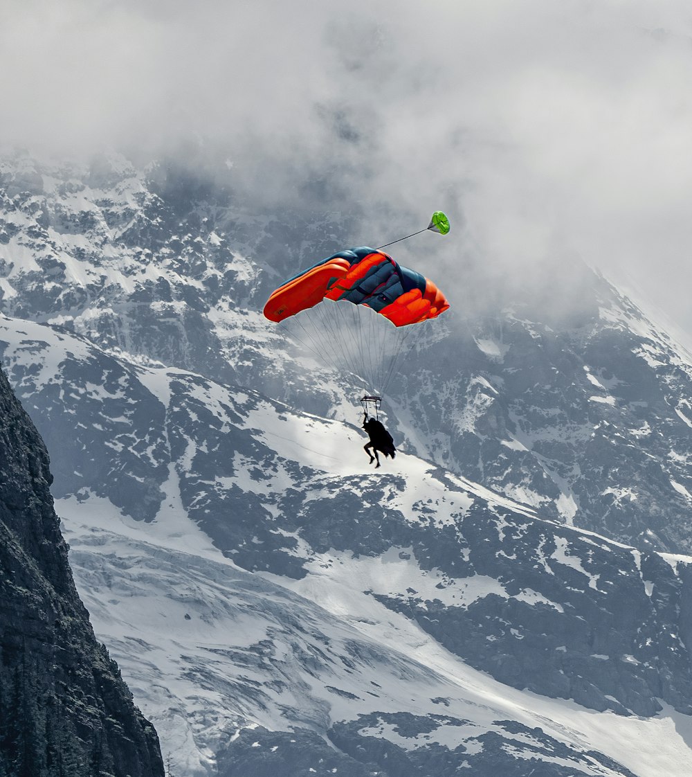 person in red and black jacket doing sky diving