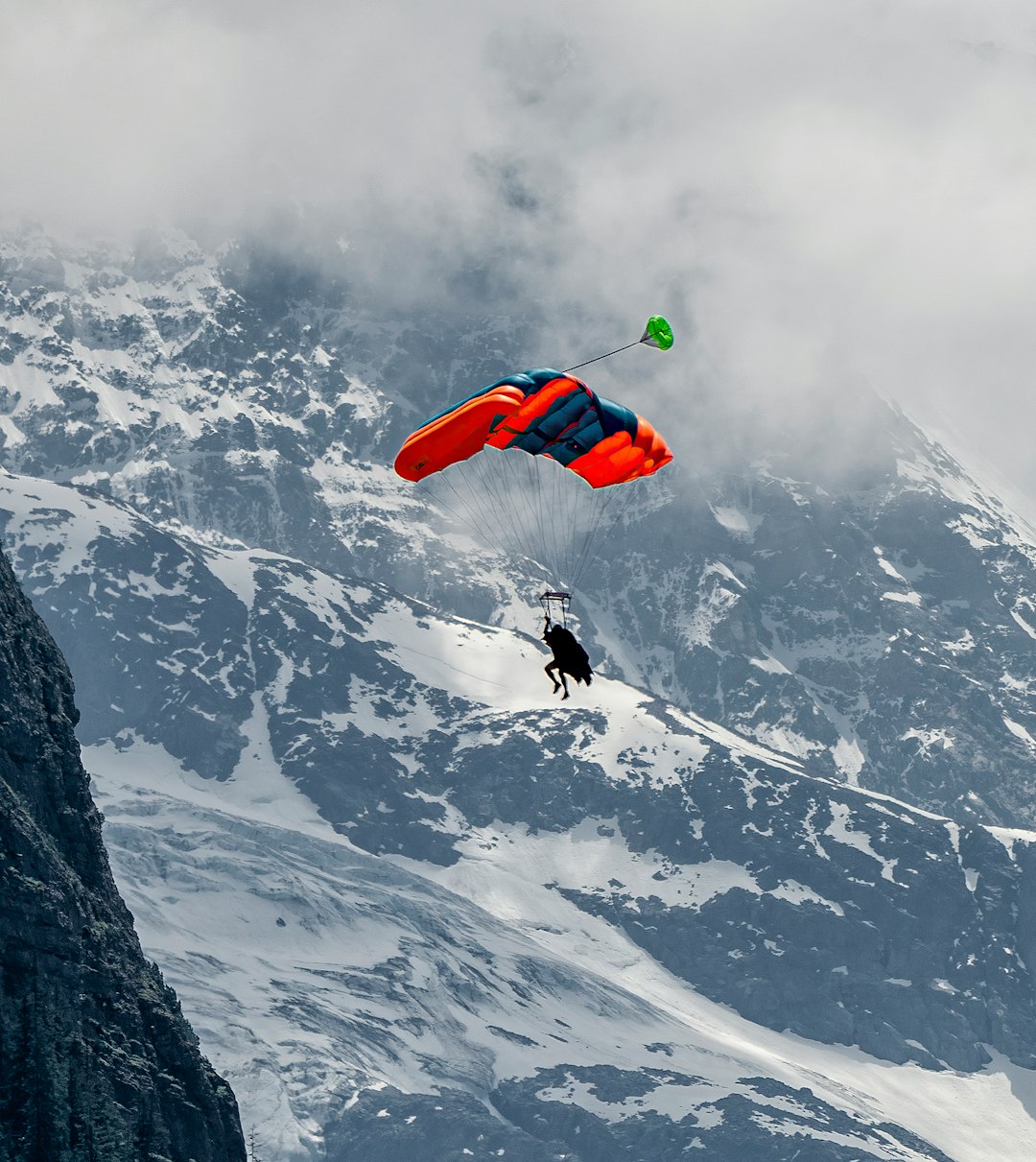 person in red and black jacket doing sky diving