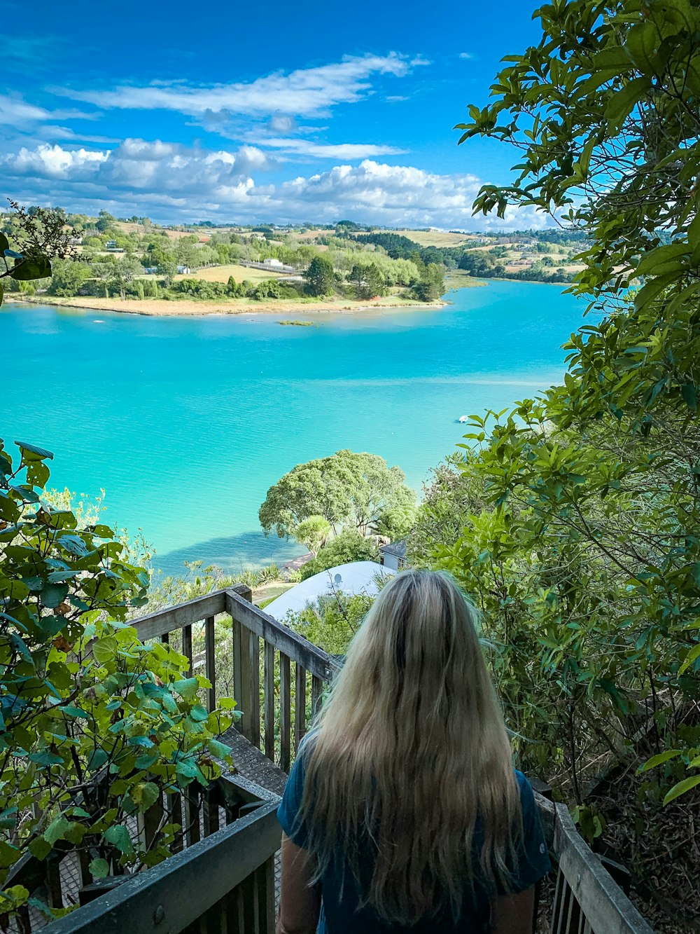 woman in black shirt standing near blue sea during daytime