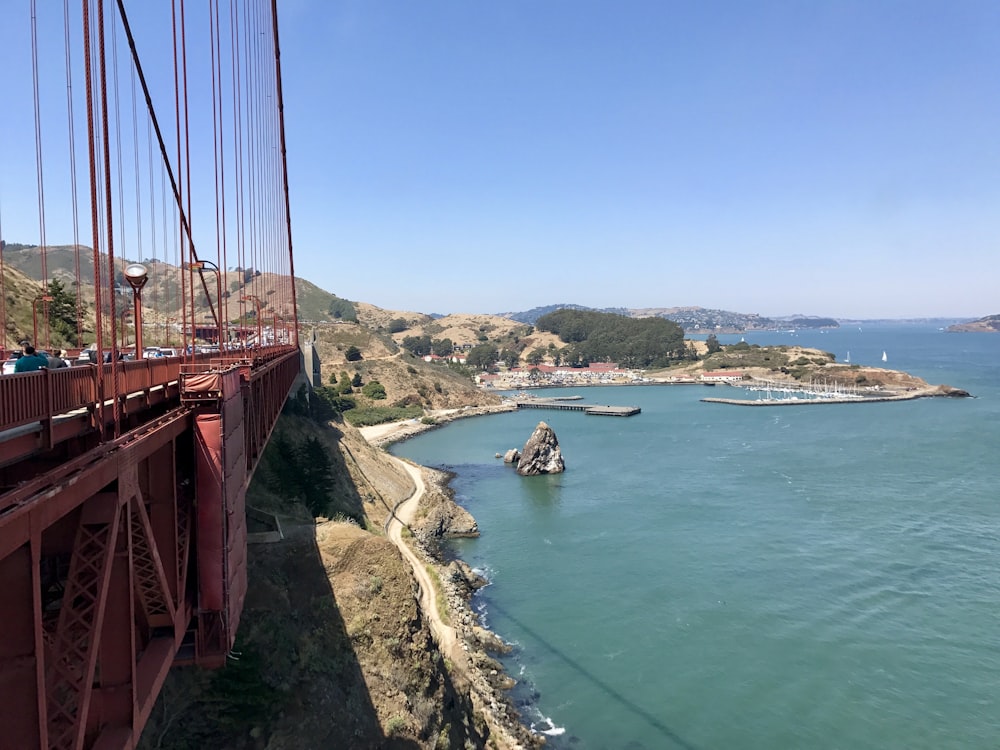 red bridge over blue sea during daytime