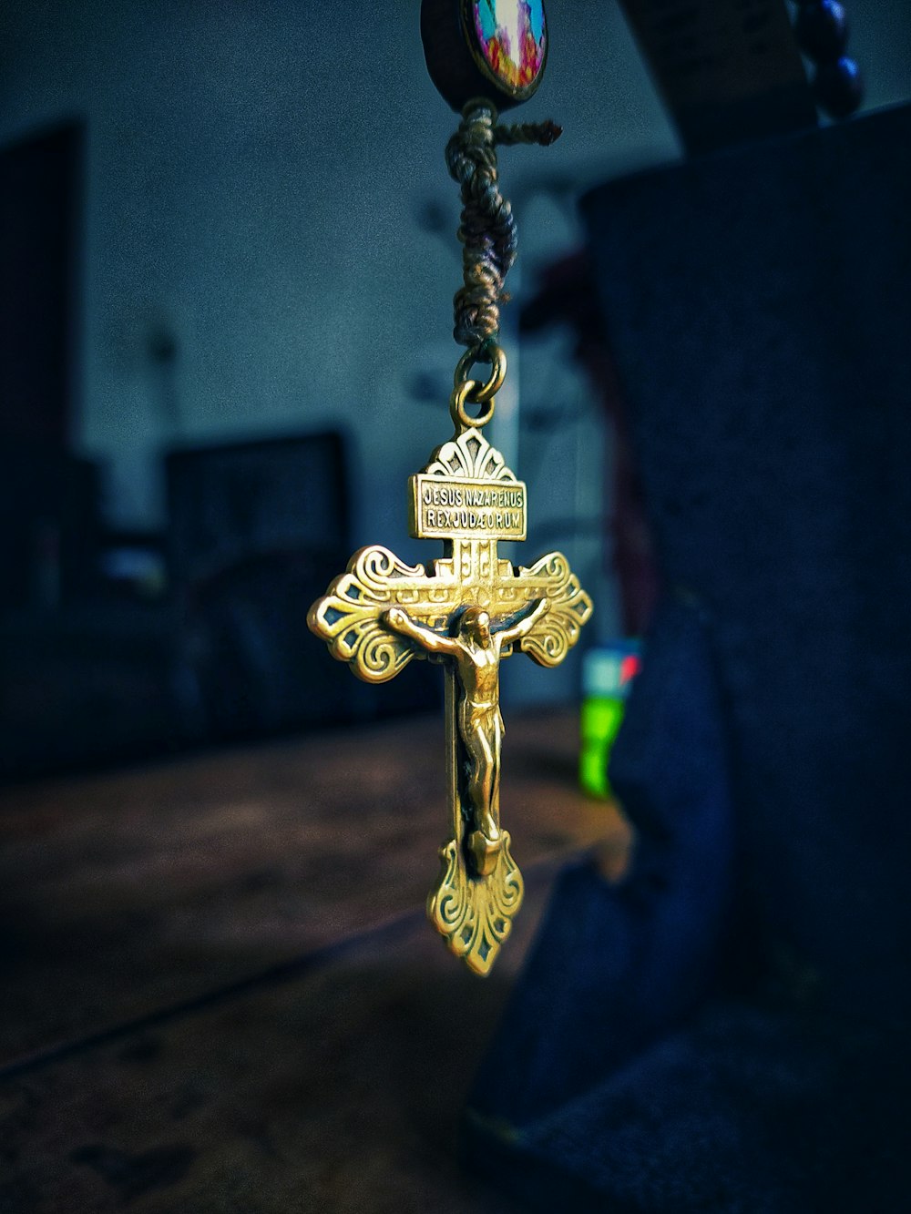 gold cross pendant on black textile
