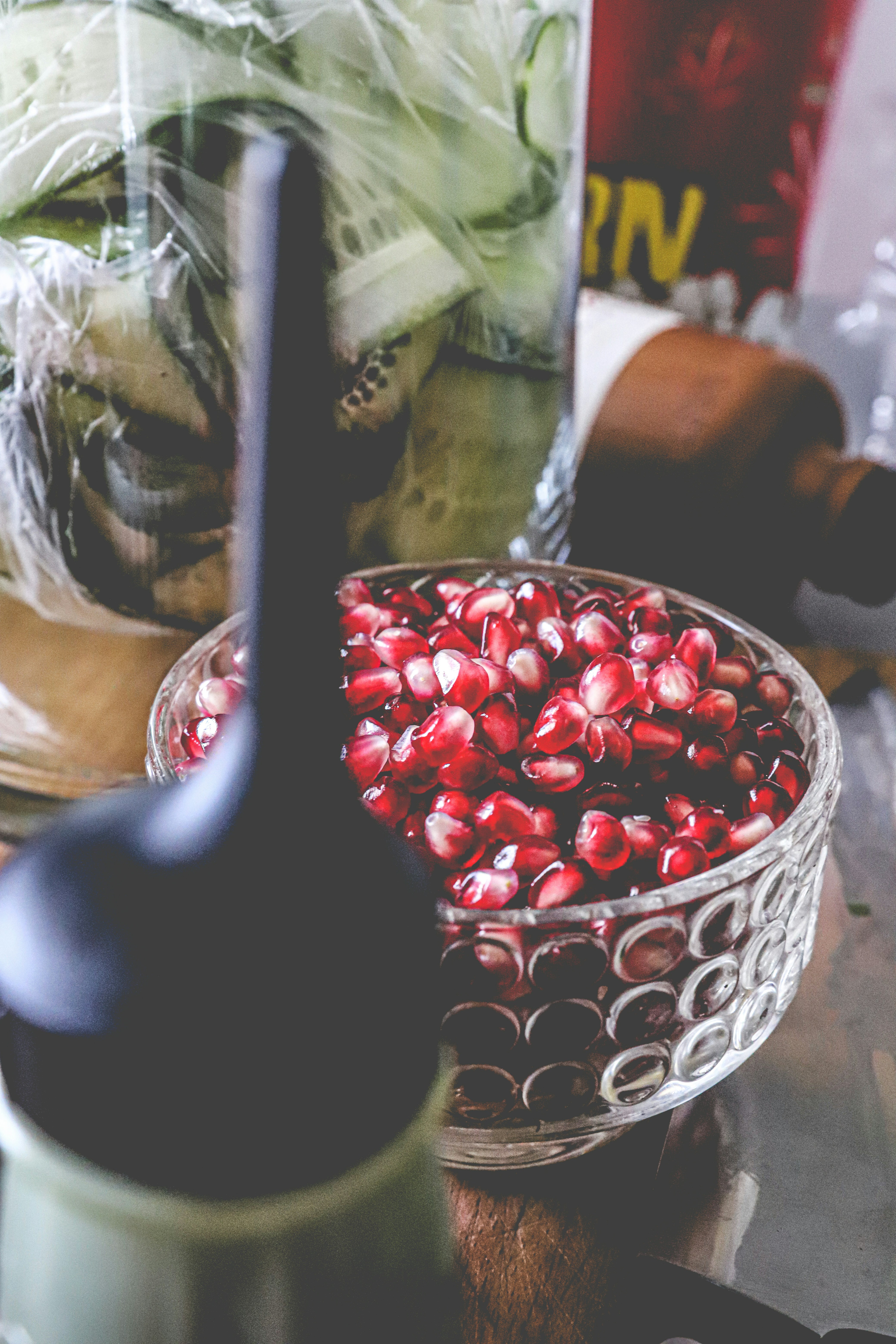 red round fruits in white and red ceramic bowl