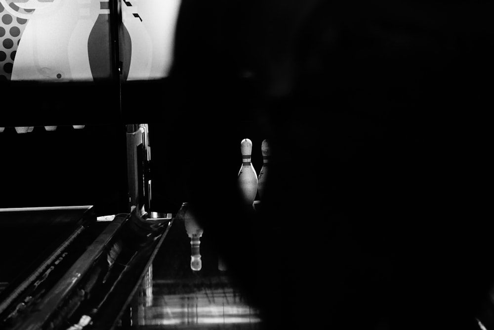 grayscale photo of person standing on the kitchen