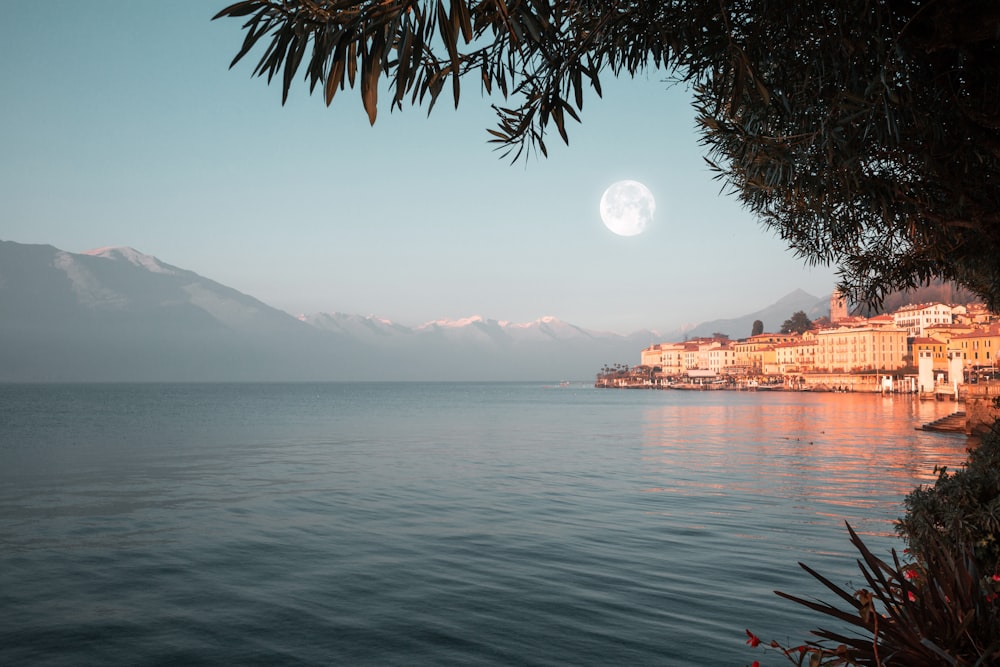 body of water near mountain during daytime