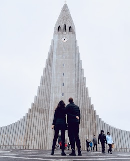 people walking on gray concrete pathway near gray concrete building during daytime