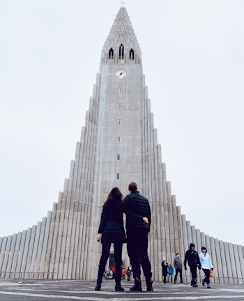 people walking on gray concrete pathway near gray concrete building during daytime