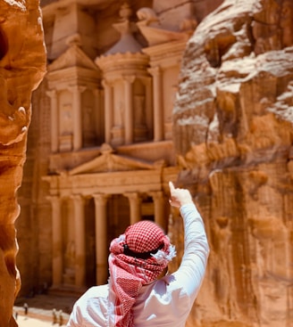 person in white long sleeve shirt and red and white hijab