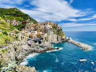 A group pausing to admire the colorful villages of Cinque Terre from a high vantage point.