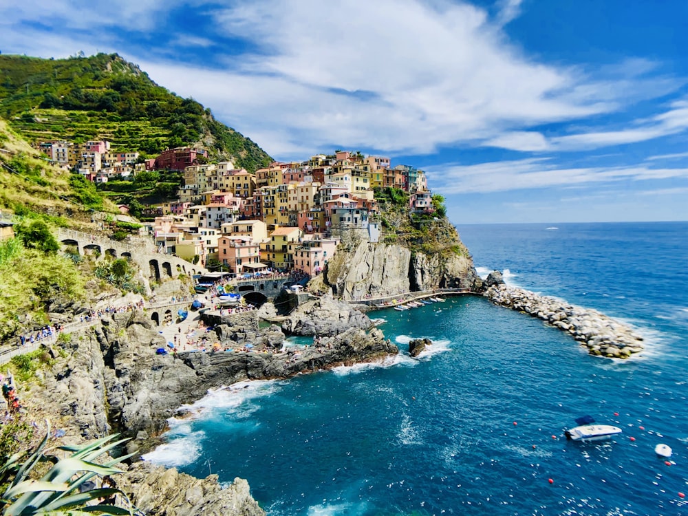 houses on mountain near sea under blue sky during daytime