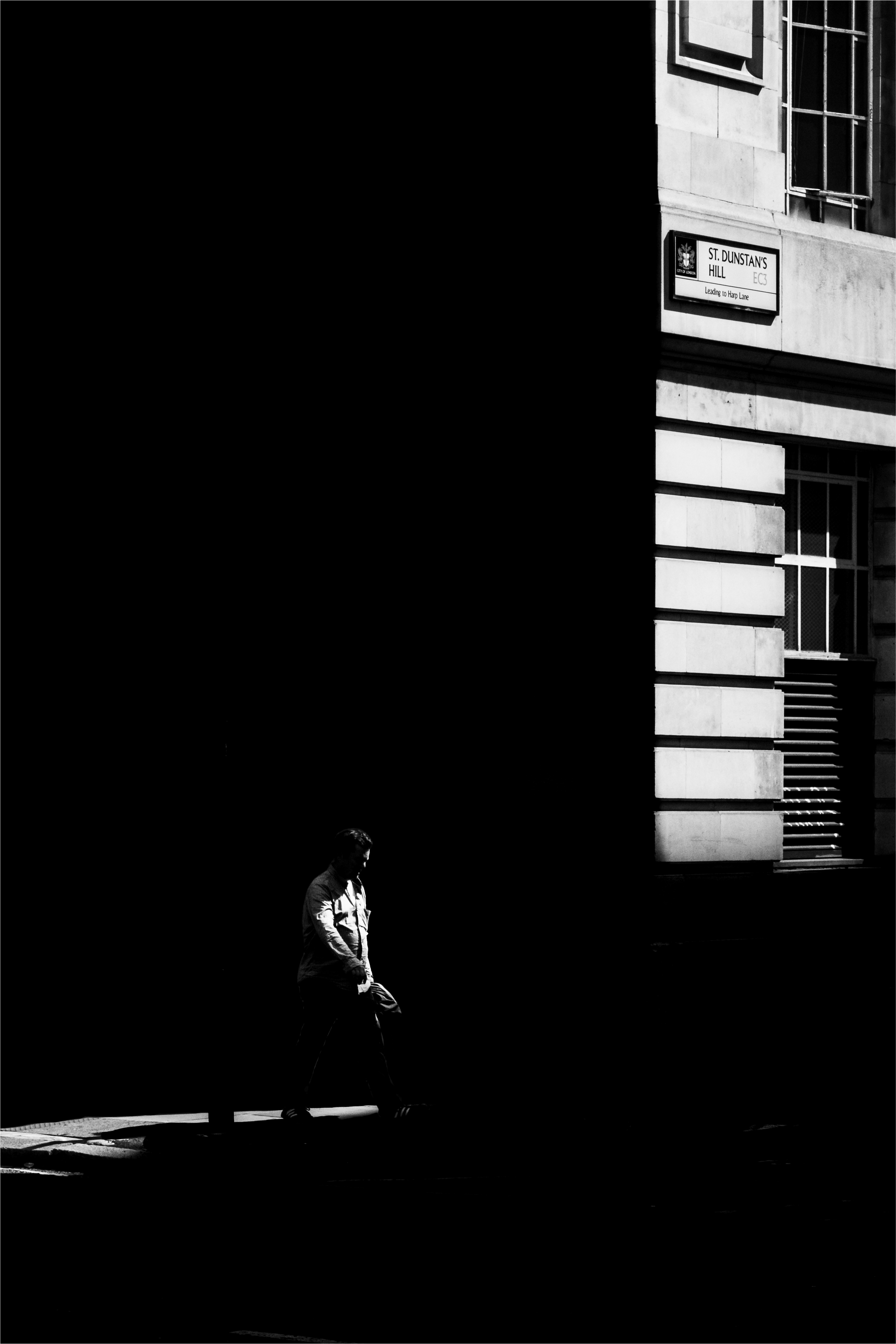 woman in black jacket standing near window
