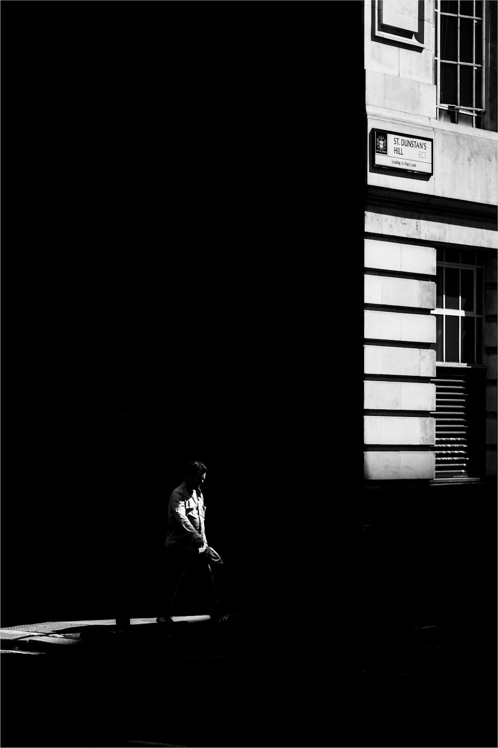 woman in black jacket standing near window