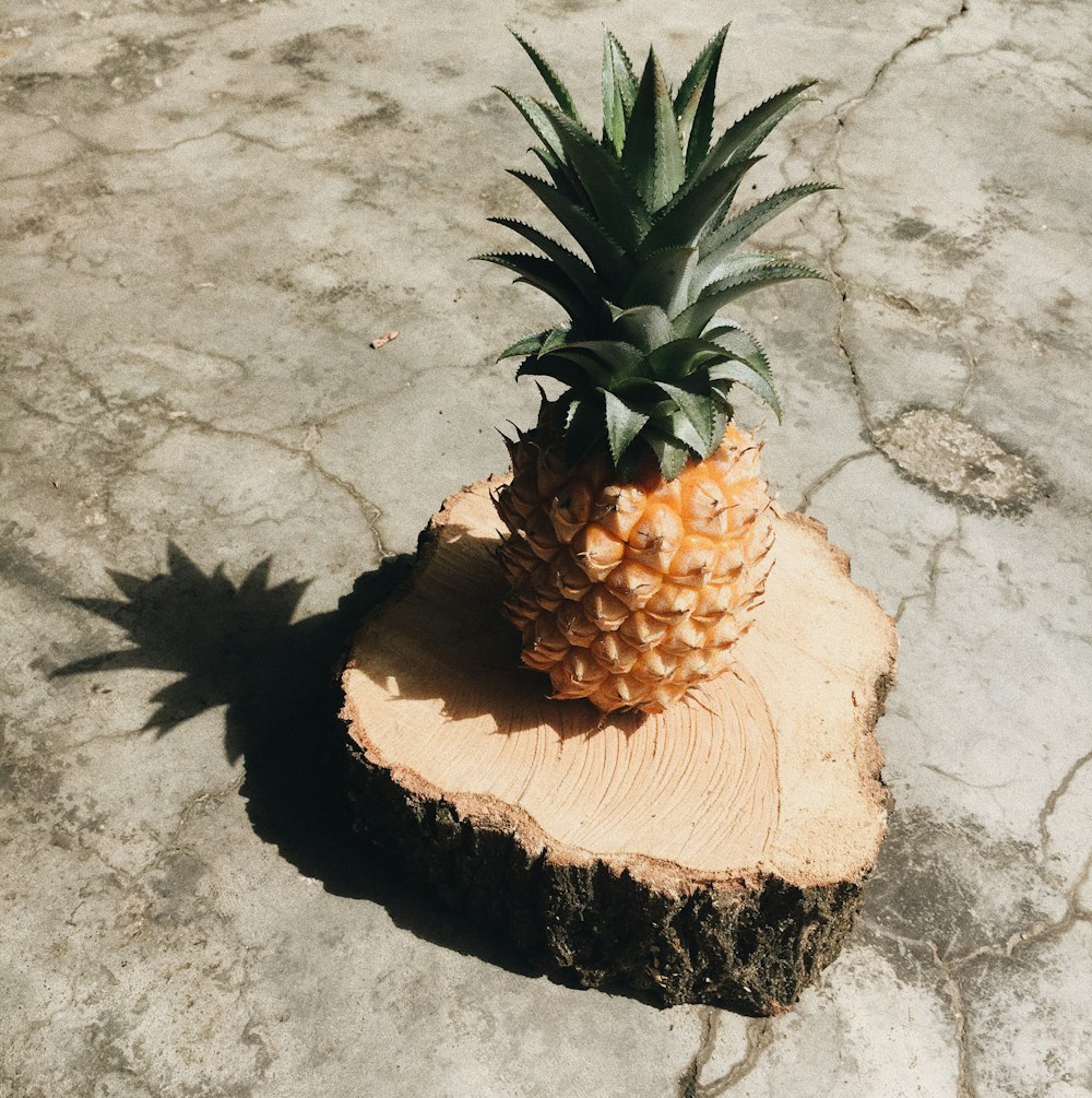 brown and green pineapple fruit on brown wooden table