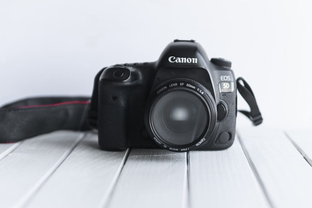 black nikon dslr camera on white table