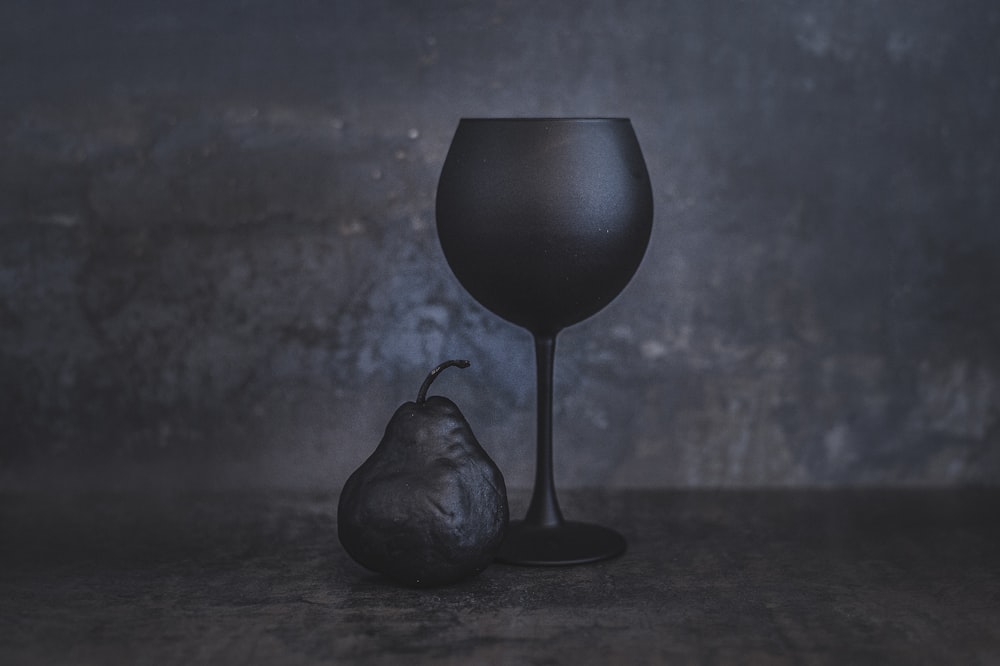 black ceramic vase on brown wooden table