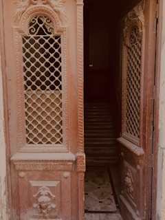 Interior view showing a row of elegant wooden doors with intricate designs