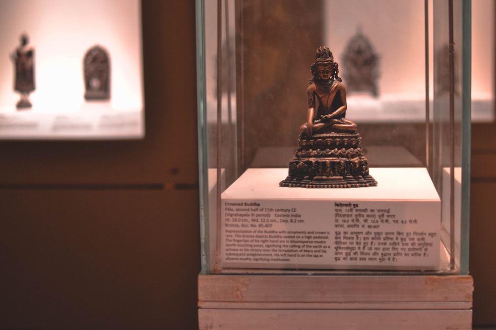 gold buddha figurine on brown wooden table