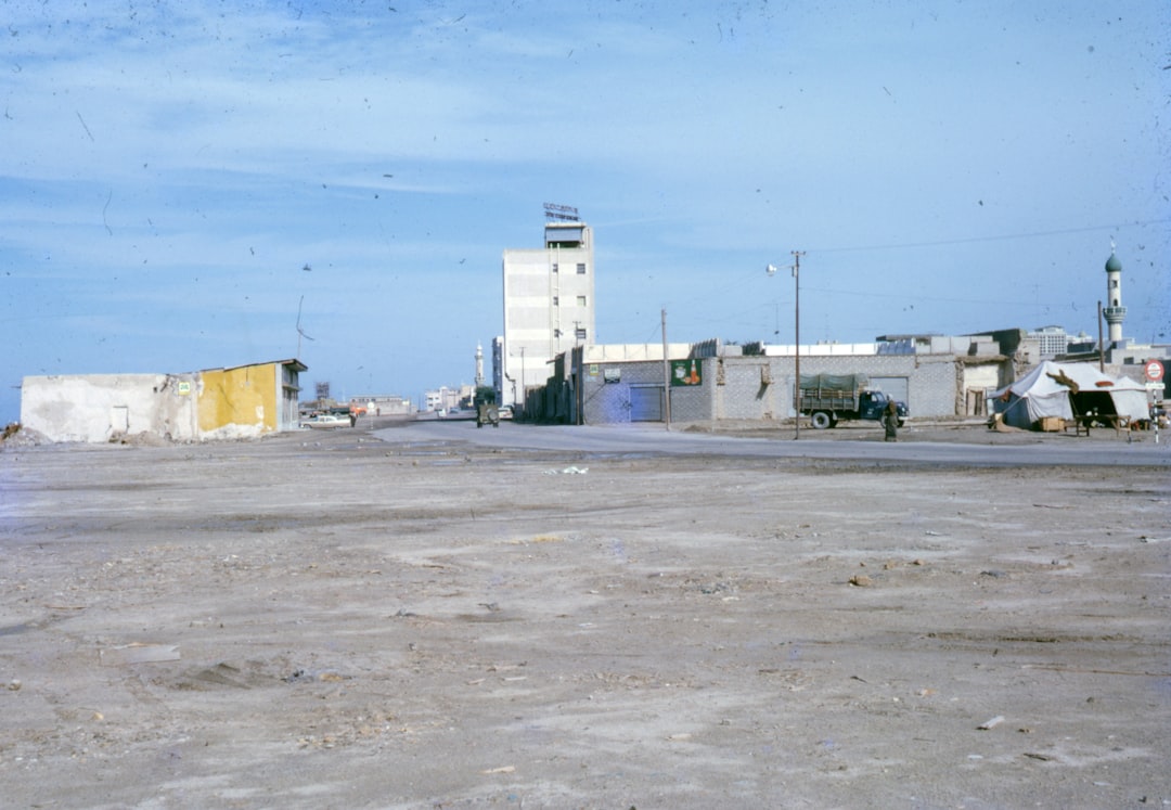 white concrete building under blue sky during daytime, kuwait, old photo, old photograph, digitised slides, saudi arabia, 1950s, 1960s, 50s, 60s, vintage, arabia, uae,<p></figure>