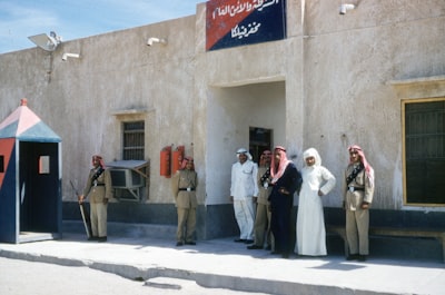 people walking on street during daytime kuwait teams background