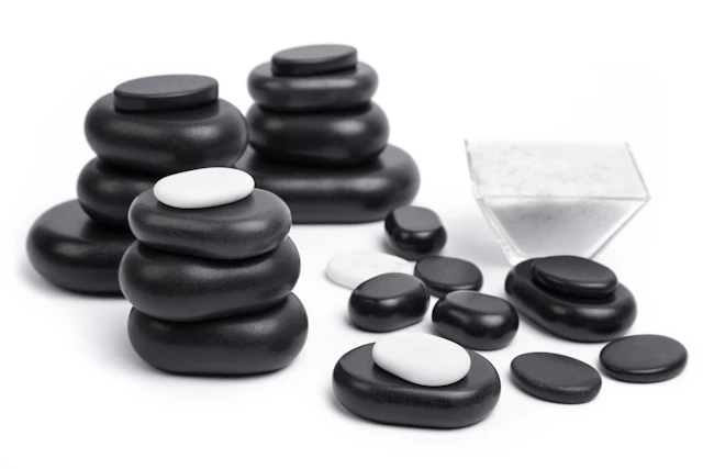Massage stones neatly arranged on a light surface