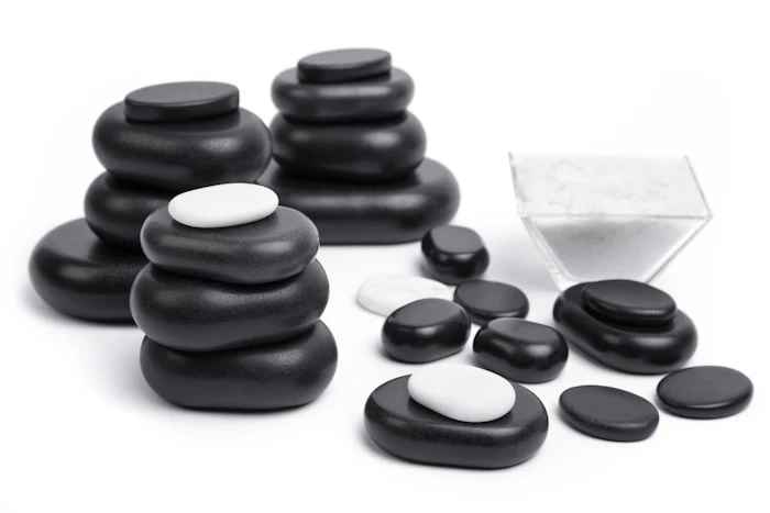 Massage stones on a light surface