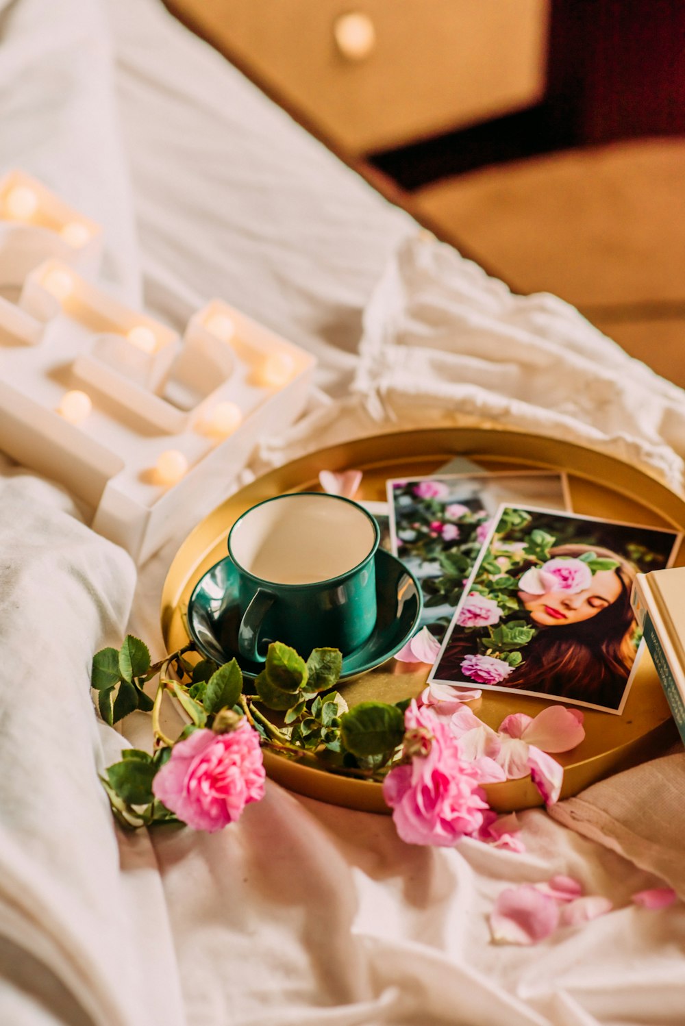 green ceramic mug on pink and white floral tray