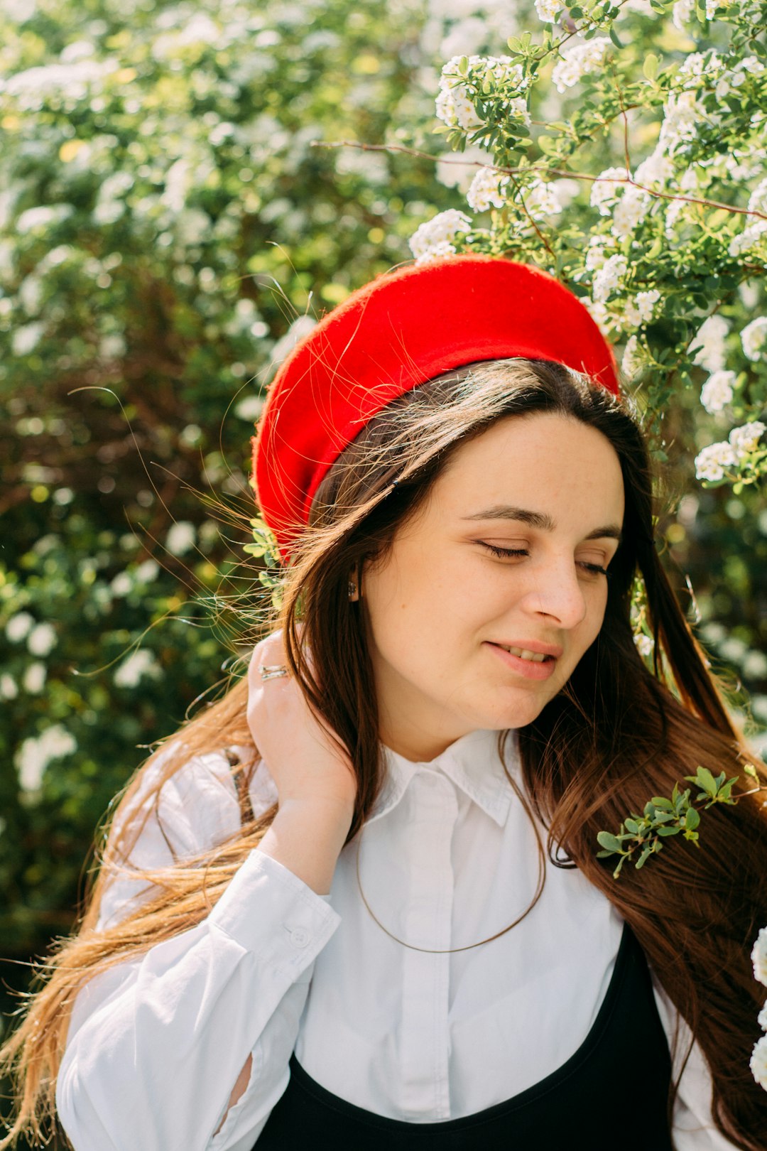 woman in white button up shirt wearing red hat