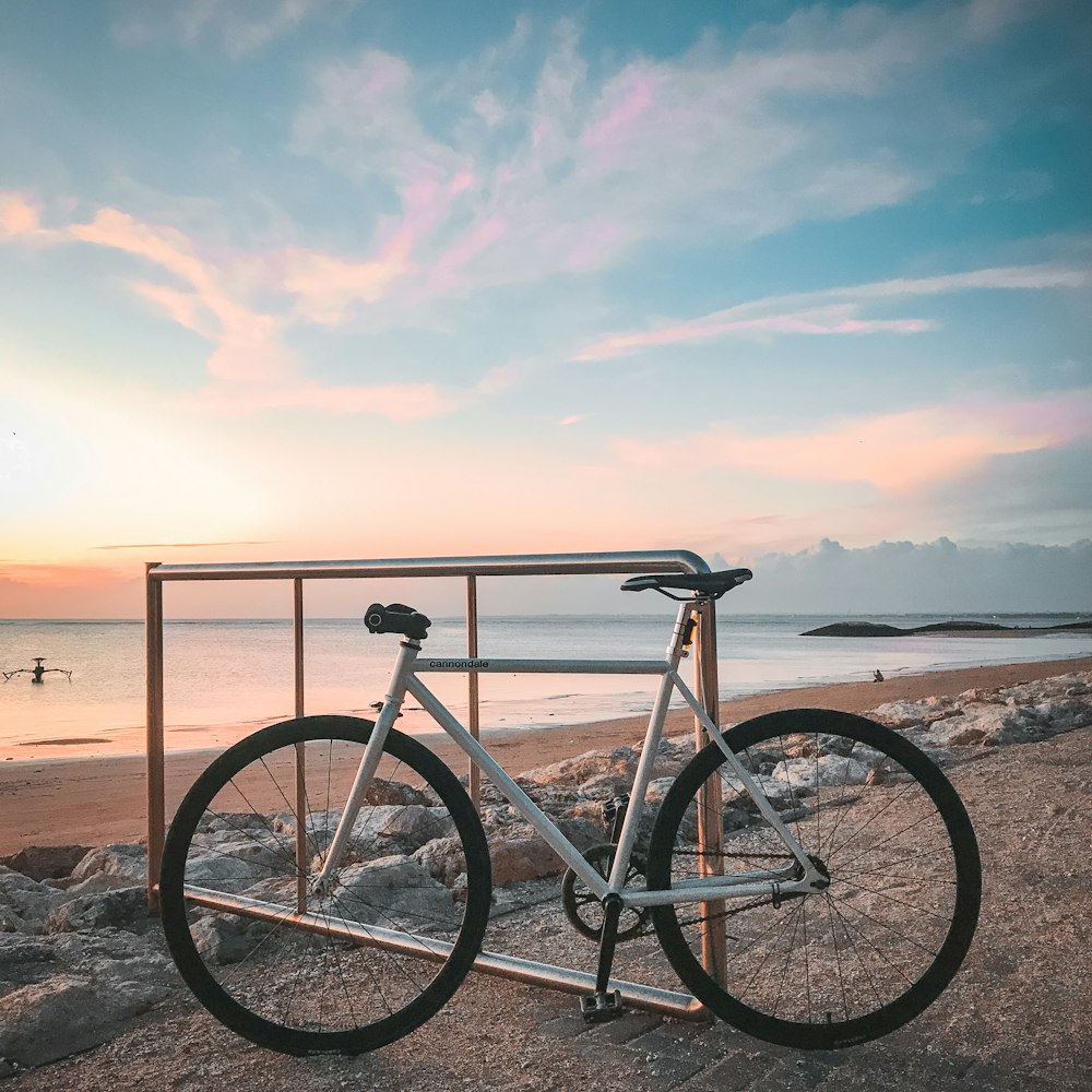 black commuter bike on brown sand during daytime