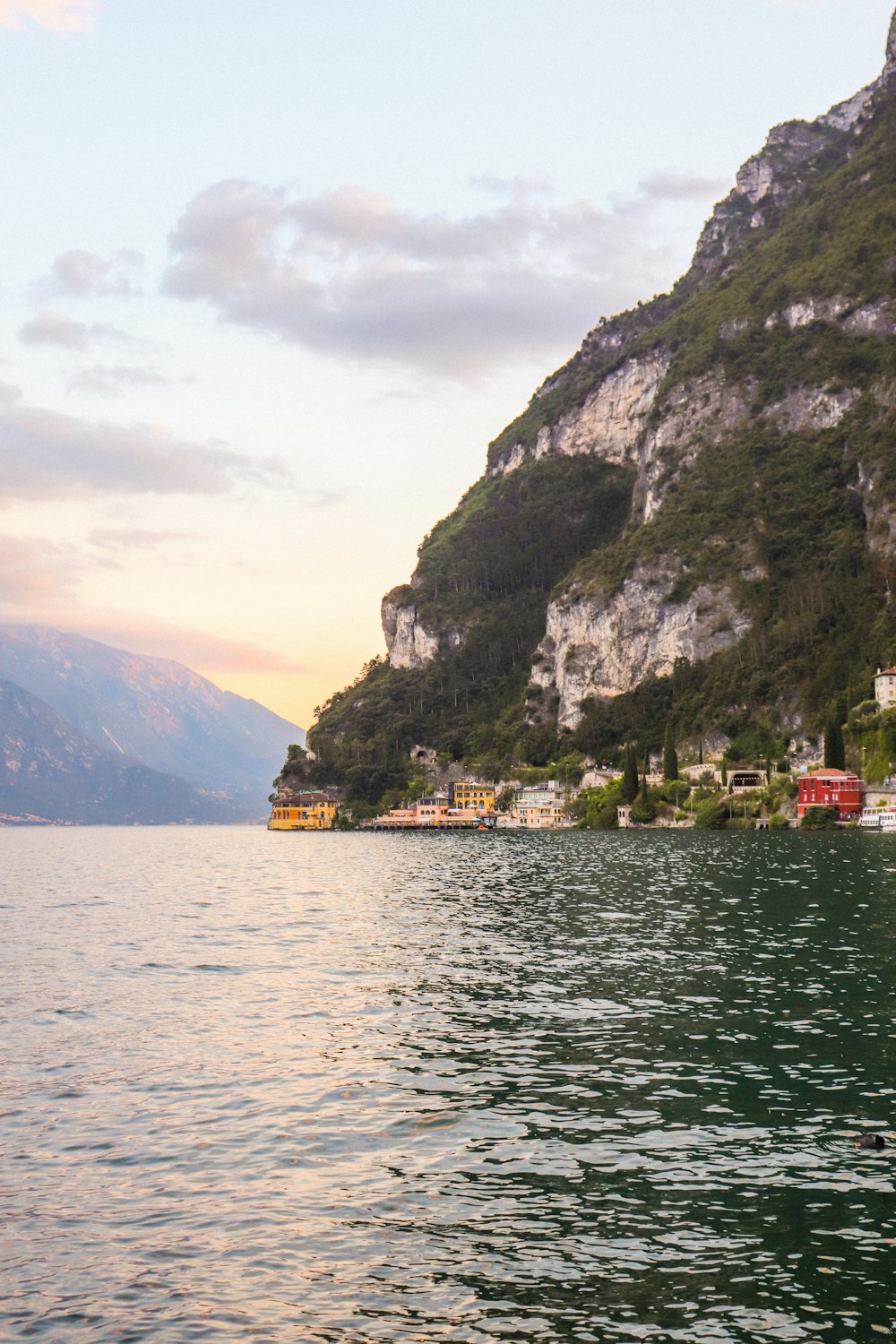 body of water near mountain during daytime