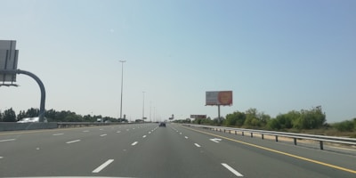 Wide shot of a newly installed advertising panel along a highway.