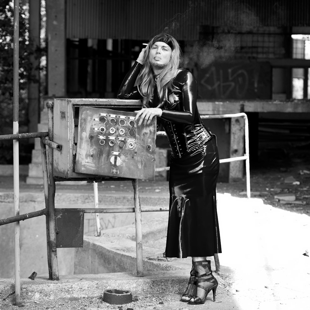 woman in black dress holding book