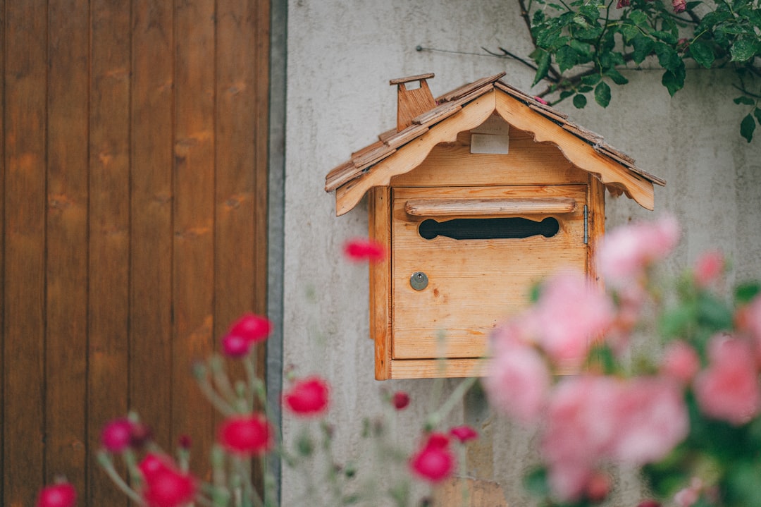 brown wooden birdhouse on gray wooden wall