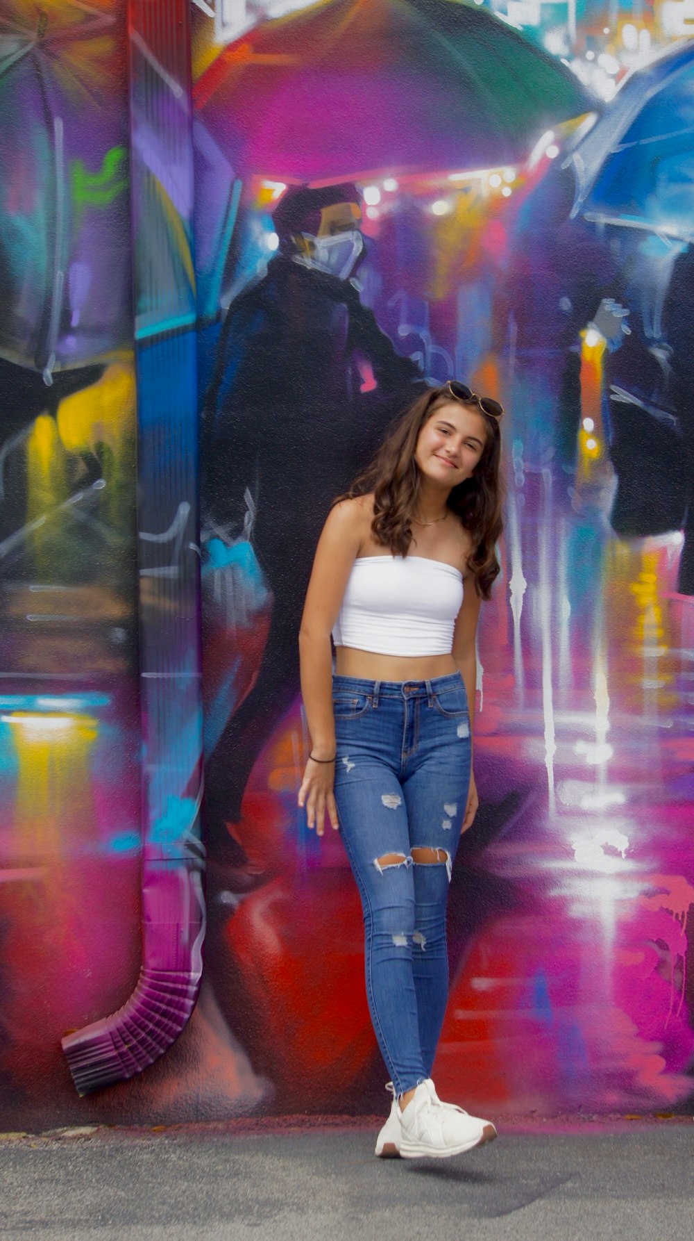 woman in white tank top and blue denim jeans