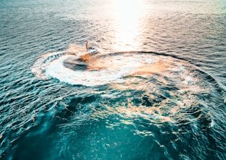 A jet-ski performing tricks on a sunny day at the beach.